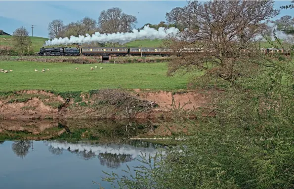  ?? JOHN TITLOW ?? From the opposite side of the River Severn, BR Standard 4MT No. 75069 deputising for No. 2999 heads towards Arley with a morning train on April 18.