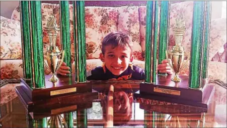  ?? SUBMITTED PHOTO ?? JJ Habres, 8 years old, with his 2016 and 2017 World Pinewood Derby first place trophies.