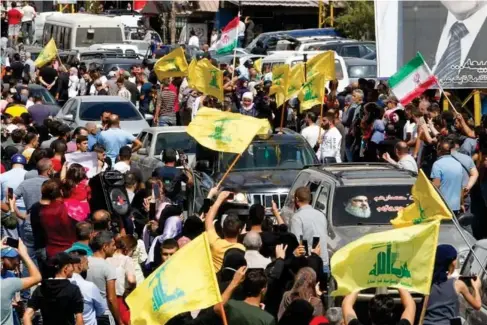  ??  ?? Hezbollah and Iranian flags are flown as a convoy carrying Iranian fuel drives through the streets (REUTERS)