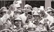  ?? PTI ?? CISF women personnel taking selfies with Rajnath Singh after a passing out parade in Tamil Nadu on Monday.