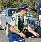  ?? BARRY HARCOURT/STUFF ?? Constable Dwight Grieve secures the ute outside the Te Anau police station.