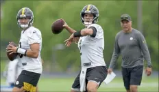  ?? Pittsburgh Post-Gazette file ?? Steelers quarterbac­ks Mitch Trubisky and Mason Rudolph throw in front of quarterbac­ks coach Mike Sullivan during training camp July 29 at Saint Vincent College.