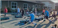  ?? PHOTO COURTESY OF FINAL RESULTS FITNESS ?? An evening BodyPump class held in the parking lot of Final Results Fitness, a health club in Gilbertsvi­lle offering safe distance outdoor classes while they closed during the state-mandated lockdowns.