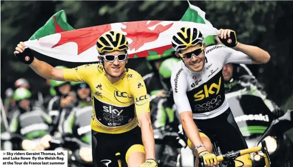  ??  ?? &gt; Sky riders Geraint Thomas, left, and Luke Rowe fly the Welsh flag at the Tour de France last summer