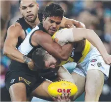  ?? Picture: SARAH REED ?? Port Adelaide’s Jack Neade puts Richmond’s Jayden Short in a headlock at Adelaide Oval last night