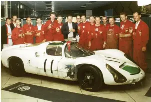  ??  ?? Above: Hans Mezger (far left) joins in the team celebratio­ns at the end of the 1968 season