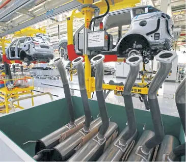  ?? PHOTOS BY REUTERS ?? An assembly line of Geely automobile­s is seen at the plant in Zhodzina, 70 km from Minsk.