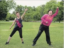  ?? JESSICA NYZNIK/EXAMINER ?? Izzy Miller, left, and Shaoling Wang do a little zumba during a press conference at Millennium Park on June 5 on the plans for Canada Day.