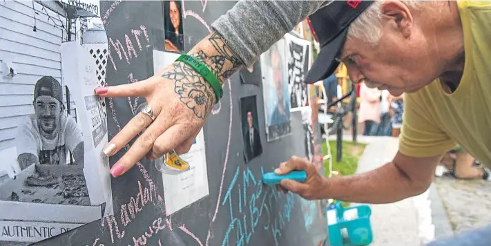  ?? Picture: Getty. ?? Tim Talbot of Portland, US, writes on the memory board in honour of his son Timothy during an Overdose Awareness vigil at Monument Square. Timothy died due to an overdose laced with fentanyl. The drug has caused hundreds of deaths across the United...