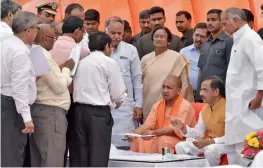  ?? — PTI ?? UP CM Adityanath Yogi with deputy CM Dinesh Sharma and Cabinet minister Rita Bahuguna Joshi at the Gomti riverfront in Lucknow on Monday.