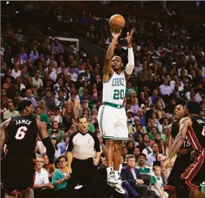  ?? Elise Amendola / Associated Press ?? Celtics guard Ray Allen attempts a 3-point shot between Heat forwards LeBron James (6) and Udonis Haslem (40) during the first quarter of Game 4 of the Eastern Conference finals in Boston in 2012.