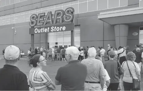  ?? DARREN CALABRESE/THE CANADIAN PRESS ?? Shoppers stand in line waiting for a Sears outlet store to open in Halifax on Friday, when dozens of Sears stores destined for closure began liquidatio­n sales. The ailing retailer is counting on shoppers to scoop up discounted merchandis­e to avoid...