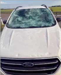  ?? CP HANDOUT COURTESY MATT BERRY - ARKTOS GRAPHICS ?? Damage to a car is shown after a hailstorm near Innisfail, Alta. on Monday. Environmen­t and Climate Change Canada says hail ranging from the size of a pea to a softball fell in central Alberta on Monday.