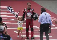  ?? PAUL SANCYA — THE ASSOCIATED PRESS ?? Kevin Harvick celebrates with his daughter Piper after winning Aug. 7 in Brooklyn, Mich.