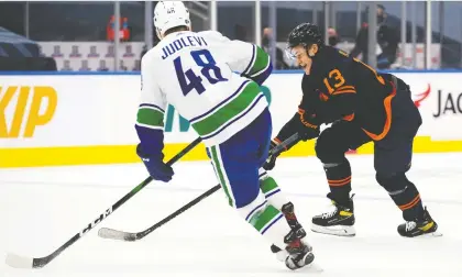  ?? DAVID BLOOM ?? Forward Jesse Puljujarvi, working here against Vancouver's Olli Juolevi, has impressed Oilers brass with his work ethic so far this season.