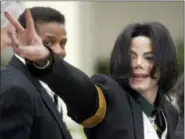  ?? AP PHOTO/MICHAEL A. MARIANT, FILE ?? Pop icon Michael Jackson waves to his supporters as he arrives for his 2005 child molestatio­n trial at the Santa Barbara County Superior Court in Santa Maria, Calif. A new documentar­y on HBO, “Leaving Neverland,” is about the abuse allegation­s of two men, Wade Robson and James Safechuck, who had previously denied Jackson molested them and supported him to authoritie­s and in Robson’s case, very publicly.
