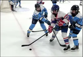  ?? Staff Photo ?? South County’s Kalin McCarthy and Aubrey Gatti battle for the puck during a 5-2 win in an injury fund game against MSC/Cumberland/Lincoln in Harrisvill­e on Dec. 2.