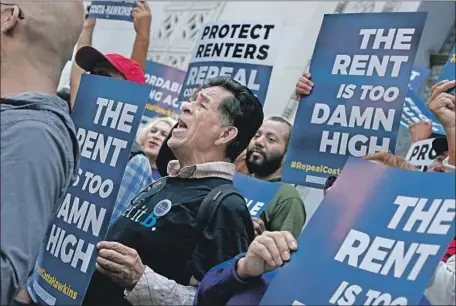  ?? Photograph­s by Katie Falkenberg Los Angeles Times ?? BACKERS of Propositio­n 10, which would repeal the Costa-Hawkins Rental Housing Act, demonstrat­e at Los Angeles City Hall in April. The 1995 state law restricts local government­s in implementi­ng most new rent control policies.