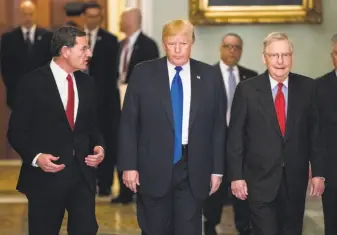  ?? J. Scott Applewhite / Associated Press ?? President Trump (center) talks with Republican senators John Barrasso of Wyoming and Mitch McConnell of Kentucky (right) about moving his agenda and passing the GOP tax bill.