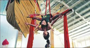  ?? PROVIDED BY REUTERS ?? A girl trains with an instructor at the Circo de los Ninos circus school in San Francisco, Mexico. The facility was set up by the world-famous Cirque du Soleil as a community project six years ago and now has a roll of 150 children.