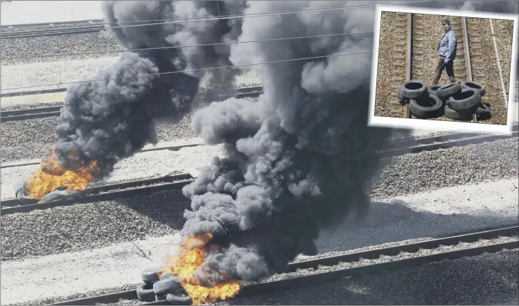  ?? Picture: AP ?? Tyres were strewn across the Channel Tunnel train tracks at Calais and set alight as another day of industrial action and migrant pressure brought misery to travellers