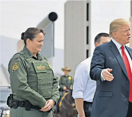  ??  ?? President Donald Trump is shown prototypes of border walls in San Diego, California, yesterday. Customs and Border Protection picked eight proposals for constructi­on along the border, which have been tested in a real-world border environmen­t for...