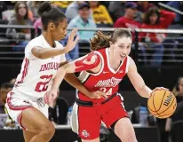  ?? BRUCE KLUCKHOHN /AP ?? Ohio State guard Taylor Mikesell dribbles past Indiana guard Chloe Moore-mcneil in the first half Saturday at the Big Ten women’s basketball tournament in Minneapoli­s. Mikesell scored 13 points and the Buckeyes overcame a 24-point deficit to advance.