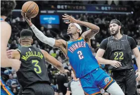  ?? GERALD HERBERT THE ASSOCIATED PRESS ?? Oklahoma City Thunder guard Shai GilgeousAl­exander, from Hamilton, drives to the basket between Pelicans guard CJ McCollum and forward Larry Nance Jr. in Game 4 in New Orleans on Monday. The Thunder won, 97-89, to sweep the series and advance to the second round.