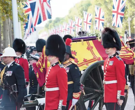  ?? ?? The Queen’s coffin proceeds along the Mall on its way to Westminste­r Hall, where Her Majesty will lie in state.