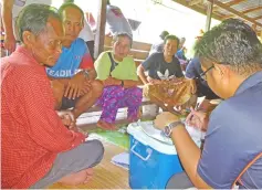  ??  ?? Villagers taking turns at the health check.