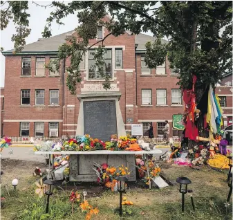  ?? PHOTOS BY DARRYL DYCK, THE CANADIAN PRESS ?? A memorial outside the former Kamloops Indian Residentia­l School in July 2021.