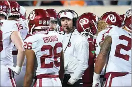  ?? SUE OGROCKI / AP ?? Oklahoma head coach Lincoln Riley talks with his players during the second half of Saturday’s game against Oklahoma State in Stillwater, Okla.