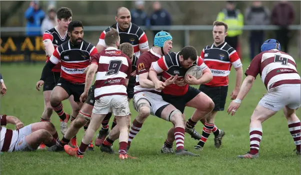  ??  ?? Jack McKenna of Wicklow tries to break a Tullow challenge.