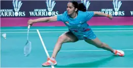  ??  ?? Awadhe Warriors’ Saina Nehwal en route to her 8- 15, 15- 10, 15- 13 win over Beiwen Zhang of Mumbai Rockets in their PBL match in Lucknow on Thursday.