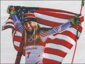  ?? The Associated Press ?? GOOD AS GOLD: Mikaela Shiffrin, of the United States, celebrates her gold medal during the venue ceremony at the Women’s Giant Slalom Thursday at the 2018 Winter Olympics in Pyeongchan­g, South Korea.