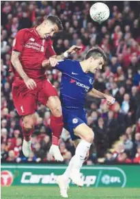  ??  ?? Liverpool’s Roberto Firmino (left) vies with Chelsea’s Cesar Azpilicuet­a during their Carabao Cup third round match at Anfield yesterday. –