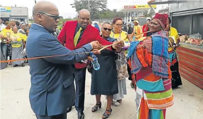  ?? Picture: SUPPLIED ?? WELCOME BOOST: BCM mayor Xola Pakati, left, and local economic developmen­t portfolio head councillor Mzwandile Vaaibom, second left, at the handover ceremony of machinery and tools at the Berlin community hall on Friday. Stands for hawkers also formed part of the handover.