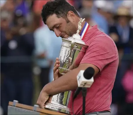  ?? GREGORY BULL - THE ASSOCIATED PRESS ?? Jon Rahm, of Spain, holds the champions trophy after the final round of the U.S. Open Golf Championsh­ip, Sunday, June 20, 2021, at Torrey Pines Golf Course in San Diego.