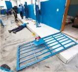  ?? (AP FOTO) ?? JAILBREAK. A guard lies dead inside the Civil Prison after a jail break in Arcahaiea, Haiti. More than 100 inmates escaped after they overpowere­d guards who were escorting them to a bathing area.