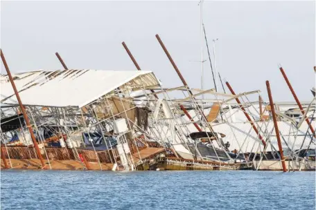  ?? LOLA GOMEZ/THE DALLAS MORNING NEWS VIA AP ?? Docks and boats are upended Friday at Lake Lewisville marina in Lewisville, Texas, after a severe storm moved through the area the night before.