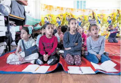  ?? AP ?? Children attend an activity at a makeshift class in Deir al-Balah.