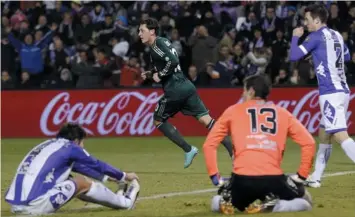  ?? (AFP) ?? Real Madrid's German midfielder Mesut Ozil (background) celebrates after scoring during the Spanish league football match Real Valladolid CF vs Real Madrid CF at Jose Zorilla stadium in Valladolid. Real Madrid won 3-2.