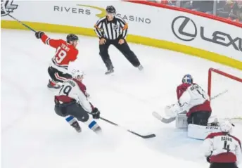  ?? Kamil Krzaczynsk­i, The Associated Press ?? Chicago Blackhawks center Jonathan Toews scores the game-winner past Avalanche goaltender Semyon Varlamov nine seconds into overtime Tuesday night at the United Center. Colorado lost 2-1.