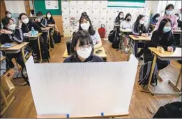  ?? Woohae Cho For The Times ?? STUDENTS at Gyungbuk Girls’ High School in Daegu, the city that was a COVID-19 hot spot in South Korea, prepare for class on the first day of school.