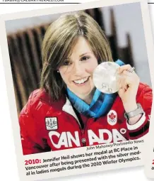  ?? John Mahoney / Postmedia News ?? 2013: Jennifer Heil shows her medal at BC Place in Vancouver after being presented with the silver medal in ladies moguls during the 2010 Winter Olympics.