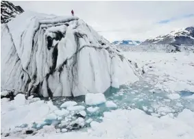  ?? THE ASSOCIATED PRESS FILE PHOTO ?? This 2008 photo released by Extreme Ice Survey shows a field technician, on an iceberg in Columbia Bay, Alaska. More ice melting is means less heat reflected into space, a recent
study has found.