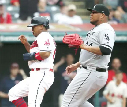  ?? RON SCHWANE/ GETTY IMAGES ?? Jose Ramirez of the Indians scores on a wild pitch thrown by Sox reliever Bruce Rondon in the sixth inning.