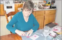  ?? MAUREEN COULTER/THE GUARDIAN ?? Sandra Bruce puts some glue on a heart for one of her Valentine’s Day cards. Bruce plans to send cards to family members including her small nieces and nephews.