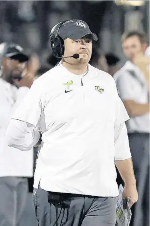  ?? JOHN RAOUX/AP ?? UCF coach Josh Heupel directs his team against East Carolina last season. Sports Illustrate­d reported the team has paused its fall camp after players voiced their concerns over safety protocols and hazard pay.