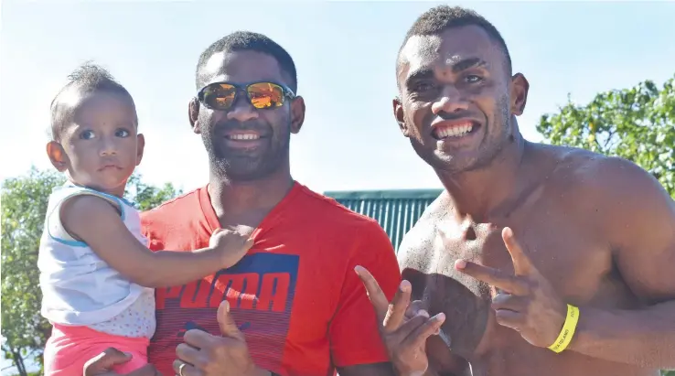  ?? Photo: Waisea Nasokia ?? Olympian and Fiji Airways Fijian 7s playmaker Vatemo Ravouvou (left) carries Grace Sau(Eroni Sau’s daughter) with Eroni Sau at the South Sea Island on June 15, 2018.